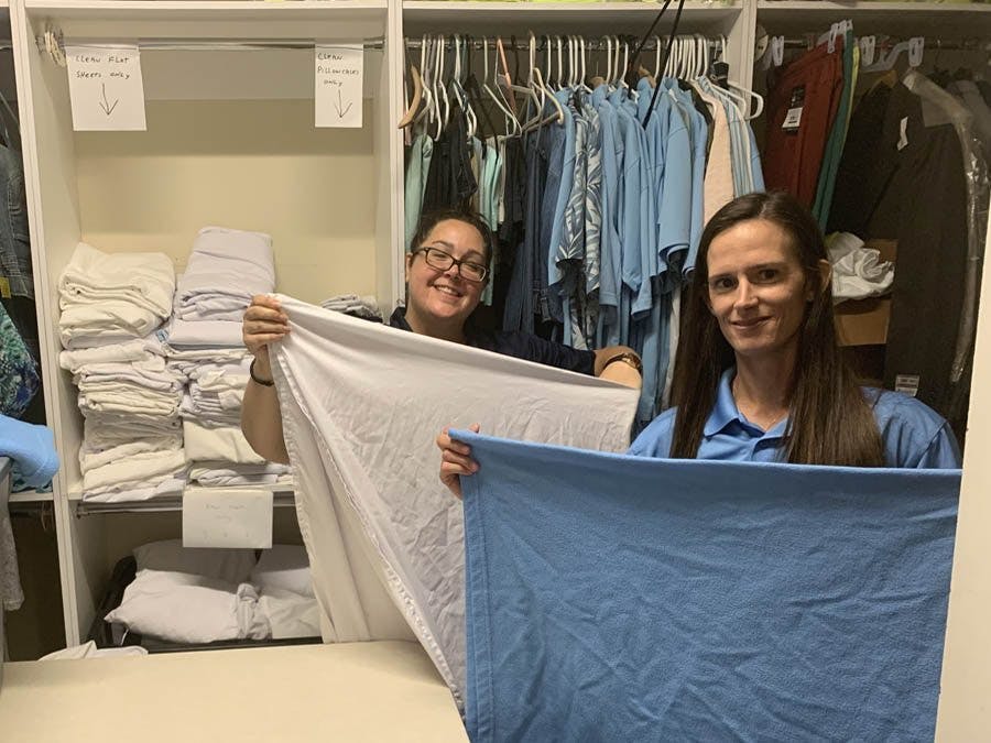 Leanne and Amanda folding laundry